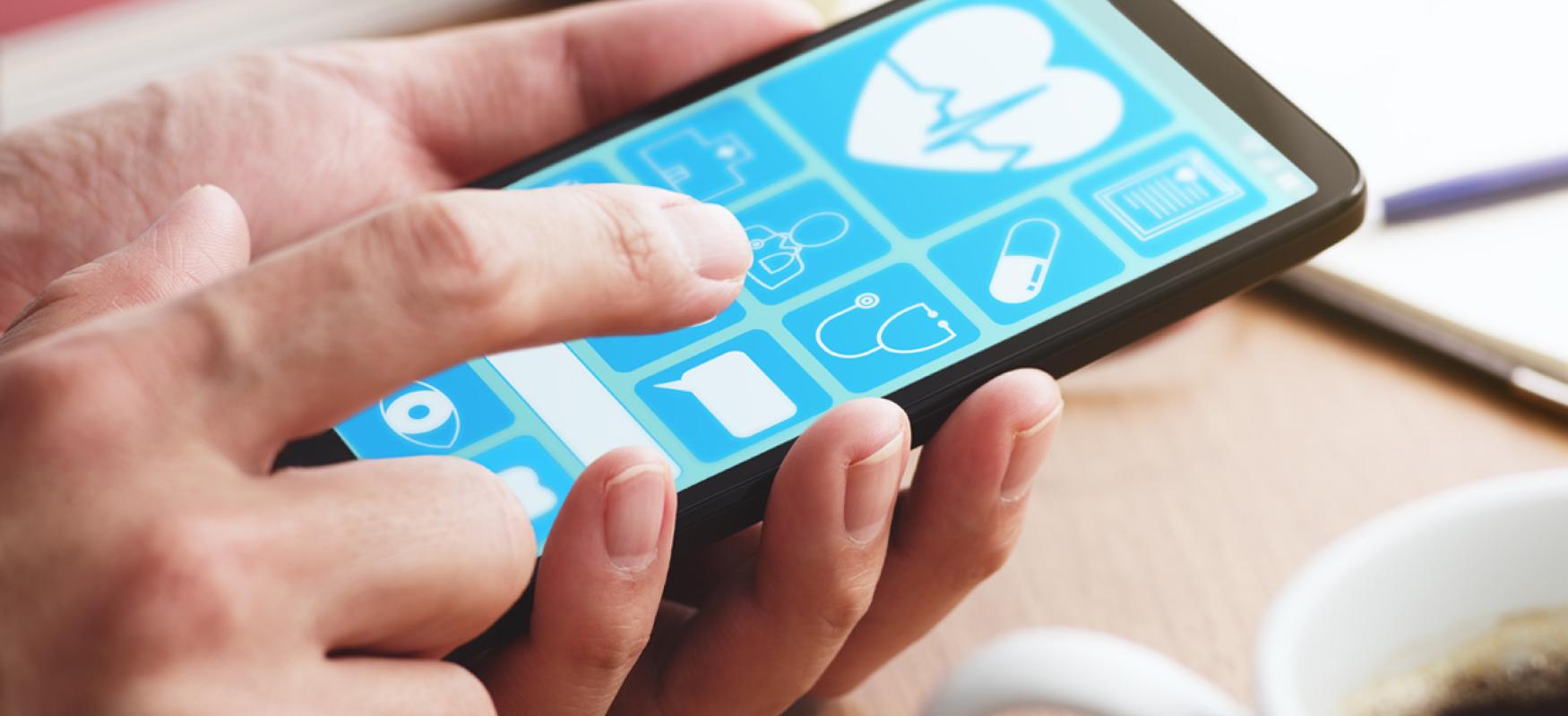 Mobile phone with health data apps on the screen held by a man