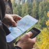 Man holding a map and a mobile