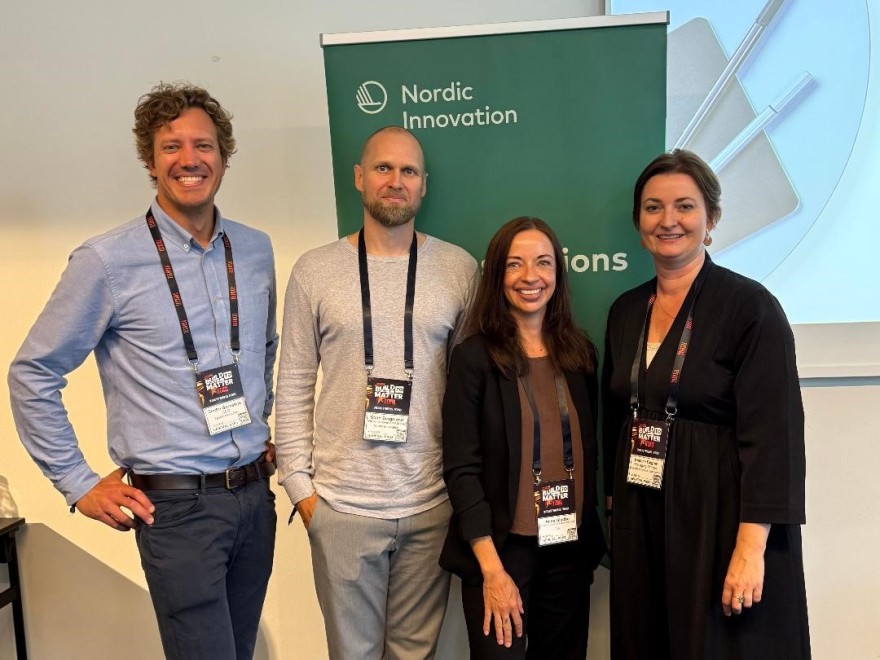 Group photo after the quantumpress conference in front of the Nordic Innovation roll-up
