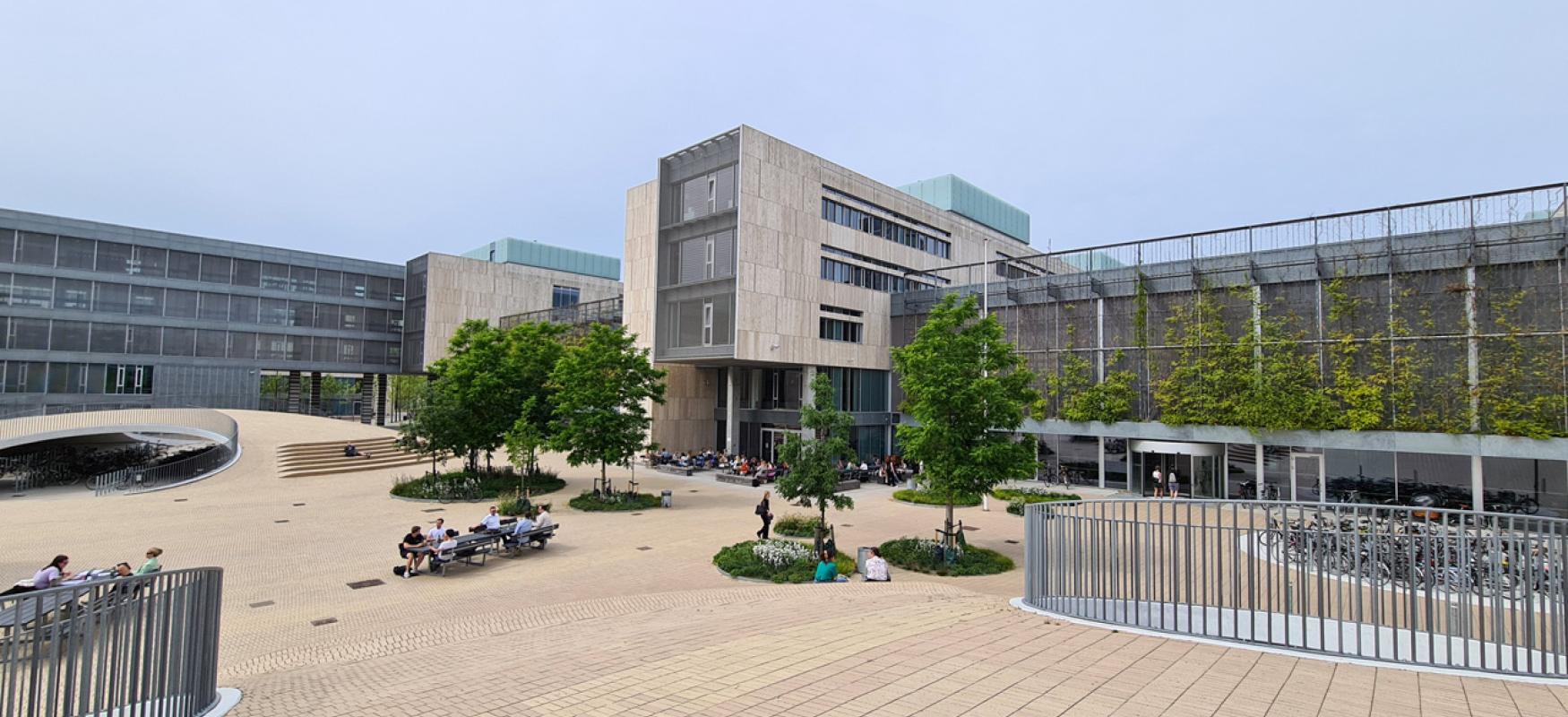 University of Copenhagen Southern Campus. A modern building and open space with trees.