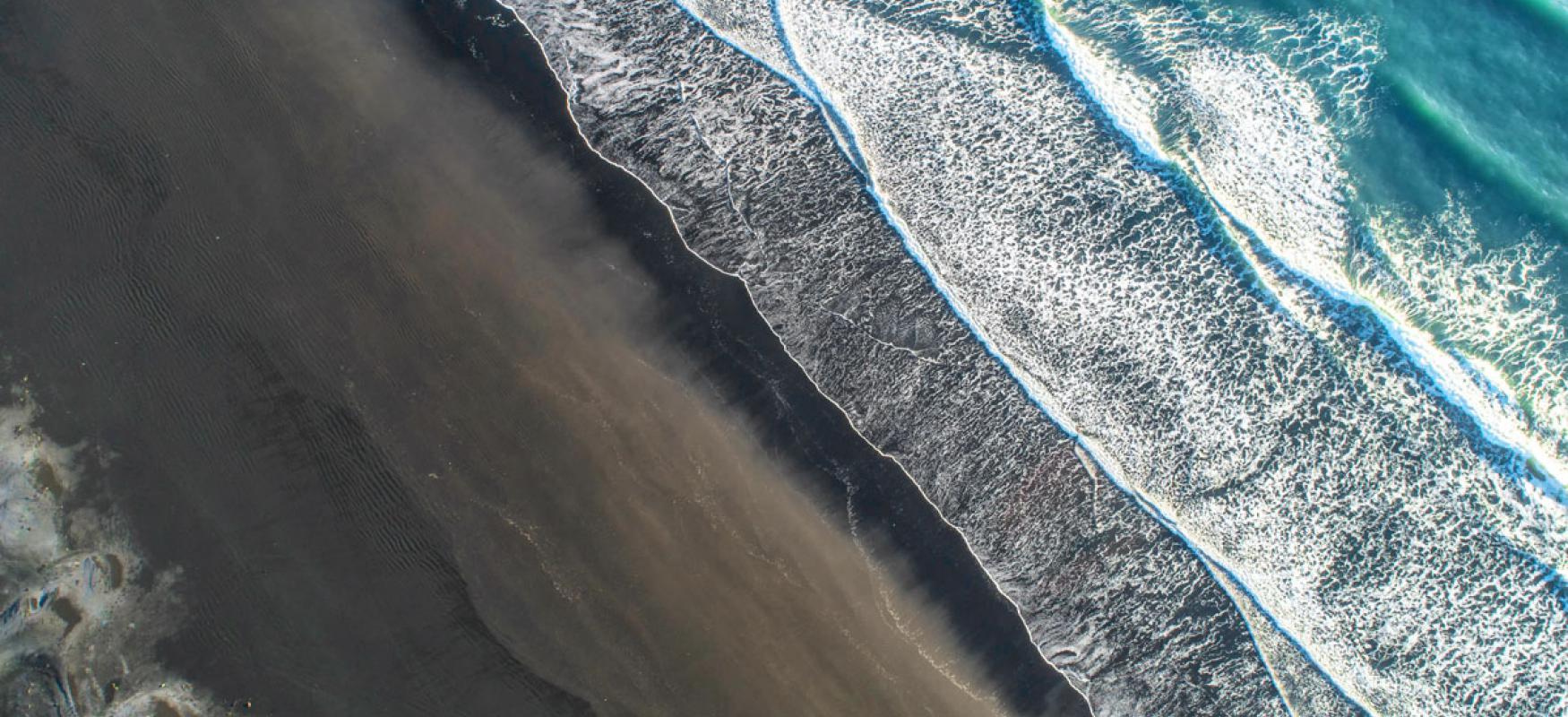 Areal view of waves washing in on a beach 