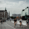 two women biking across a bridge in Copenhagen